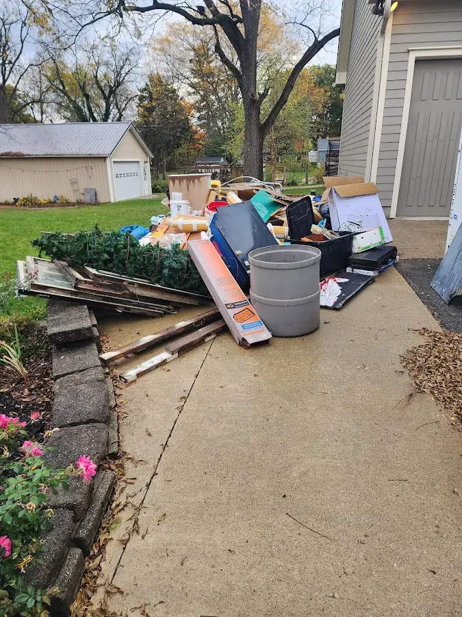 Dumpster being loaded with debris for 12 Yard Dumpster Rental in Collinsville